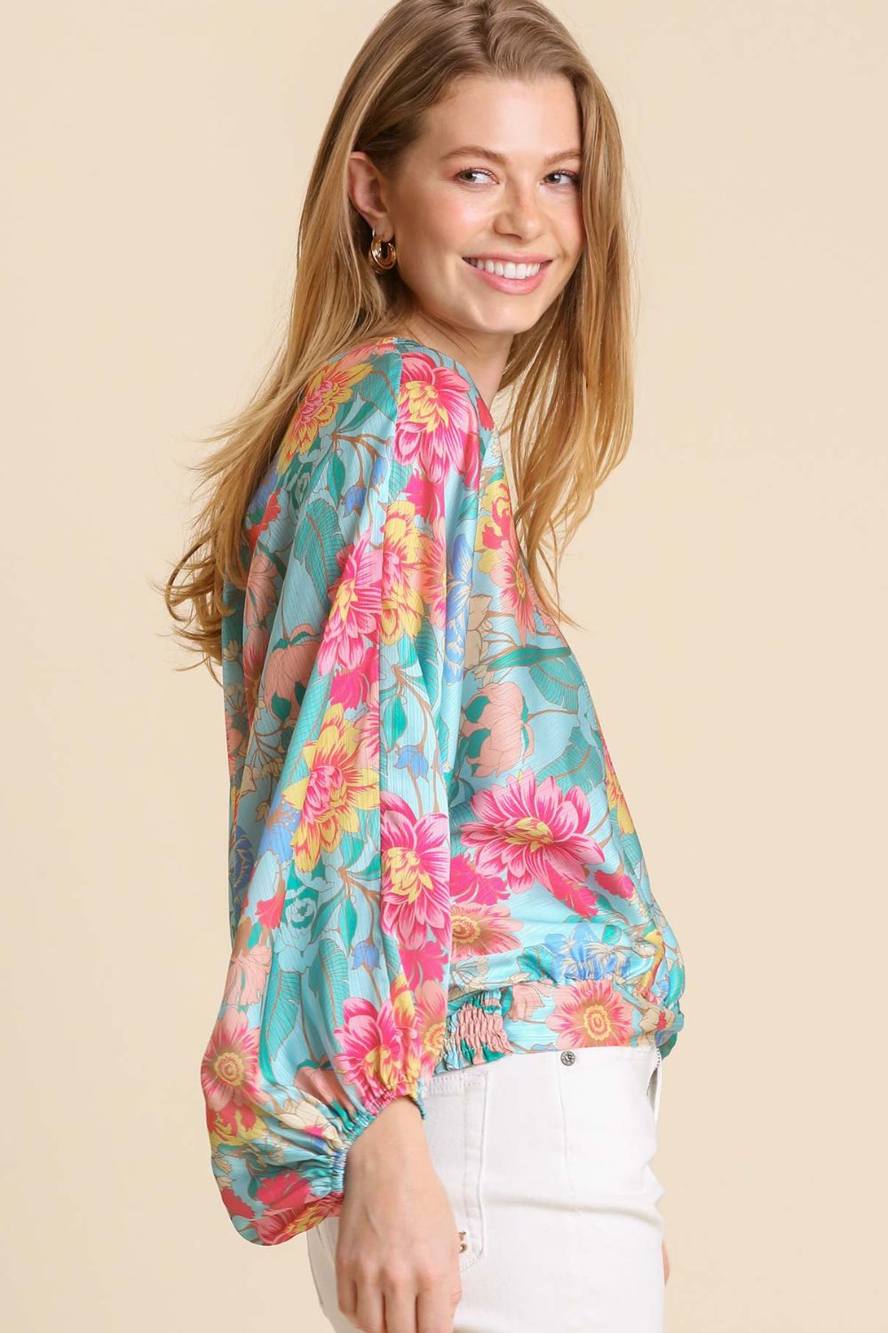 Elegant floral print blouse with a flattering V-neckline and smocked back hem, perfect for a feminine and stylish look.