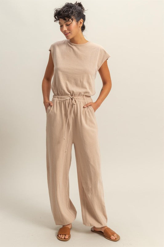 Chic back keyhole jumpsuit with cap sleeves and a drawstring waist for a stylish and comfortable look.