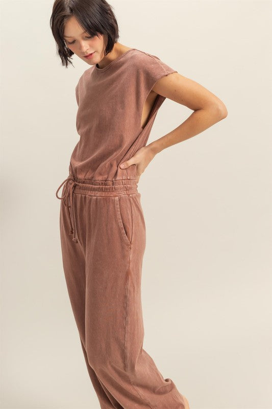 Stylish back keyhole cap sleeve jumpsuit with drawstring waist in a lightweight fabric.