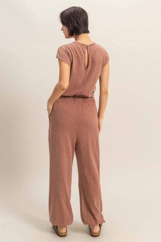 Stylish back keyhole cap sleeve jumpsuit with drawstring waist in a lightweight fabric.