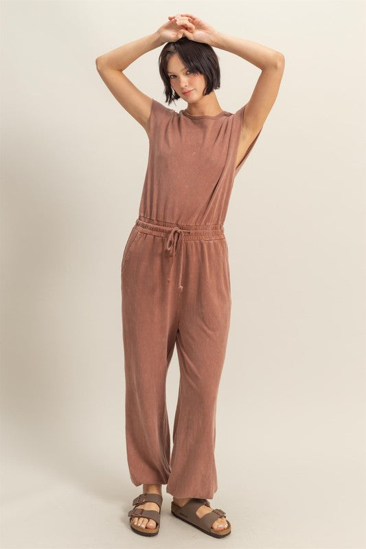 Stylish back keyhole cap sleeve jumpsuit with drawstring waist in a lightweight fabric.