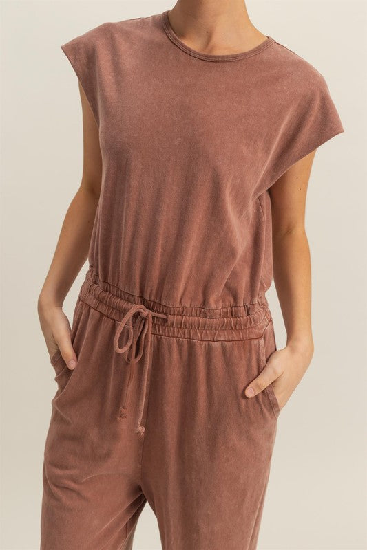 Stylish back keyhole cap sleeve jumpsuit with drawstring waist in a lightweight fabric.