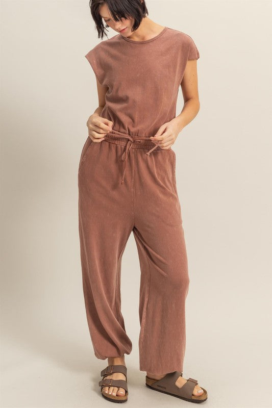 Stylish back keyhole cap sleeve jumpsuit with drawstring waist in a lightweight fabric.