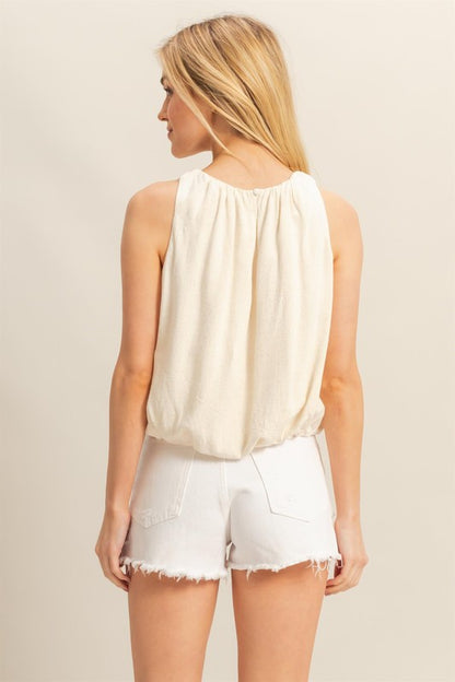 Bubble hem round neck sleeveless blouse in a chic and versatile design, perfect for casual and dressy looks.