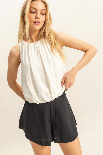 Bubble hem round neck sleeveless blouse with a stylish and relaxed fit, perfect for any occasion.