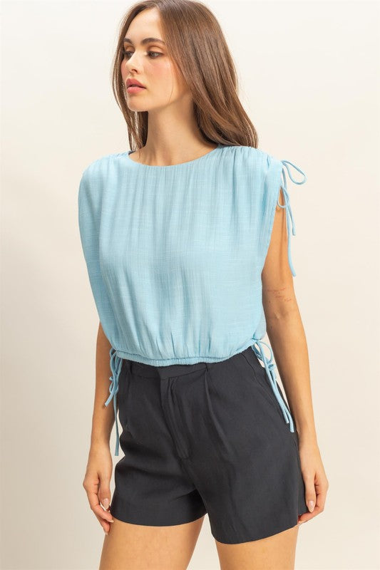 Women's bubble hem sleeveless blouse with side tie detail and round neck – stylish and versatile top