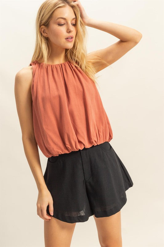 Bubble hem round neck sleeveless blouse in a chic design, perfect for layering or wearing solo for a stylish, effortless look.