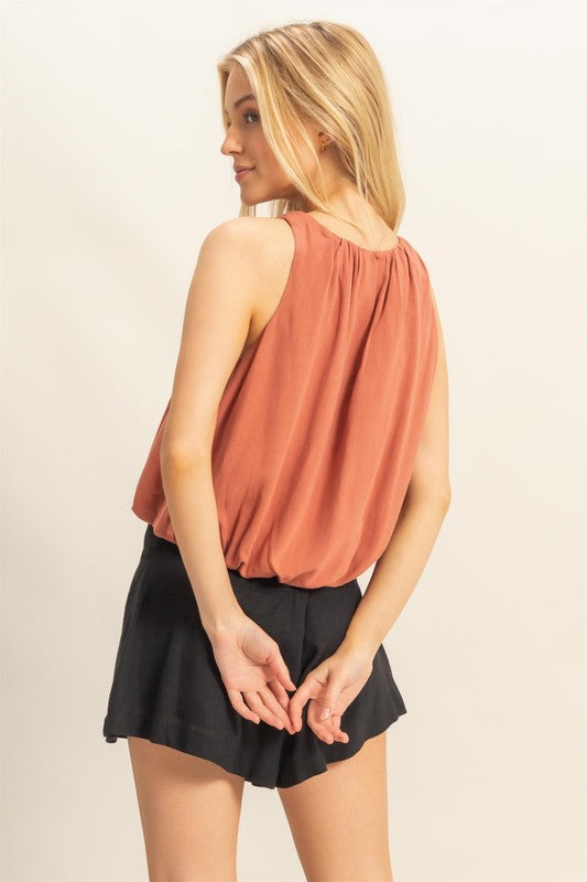 Bubble hem round neck sleeveless blouse in a chic design, perfect for layering or wearing solo for a stylish, effortless look.