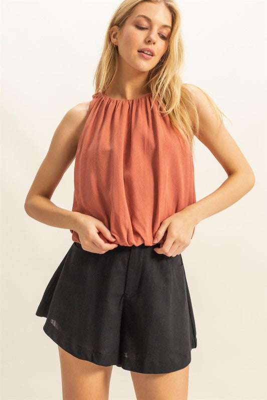 Bubble hem round neck sleeveless blouse in a chic design, perfect for layering or wearing solo for a stylish, effortless look.