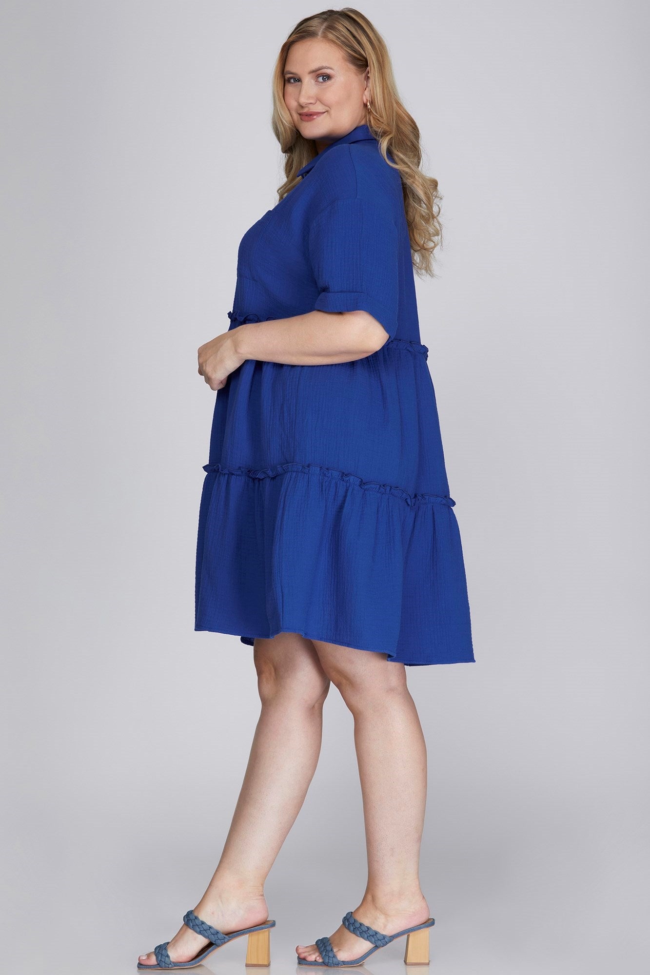 Chic button-front mini dress with frill detailing and tiered layers for a stylish and feminine look.