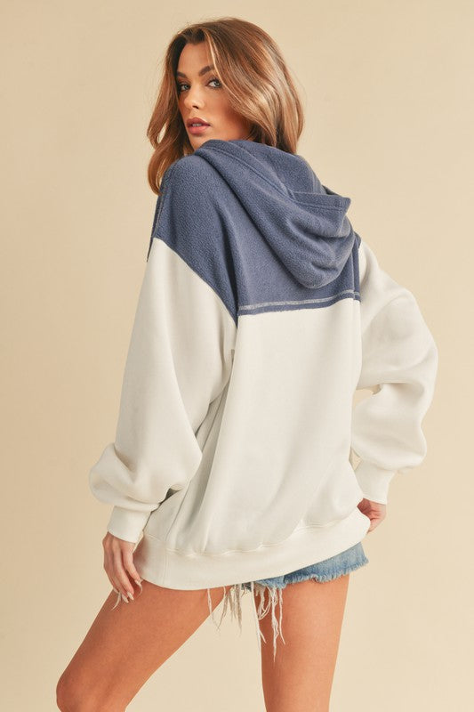 Trendy color block drop shoulder hoodie with a cozy kangaroo pocket, perfect for casual and stylish wear.