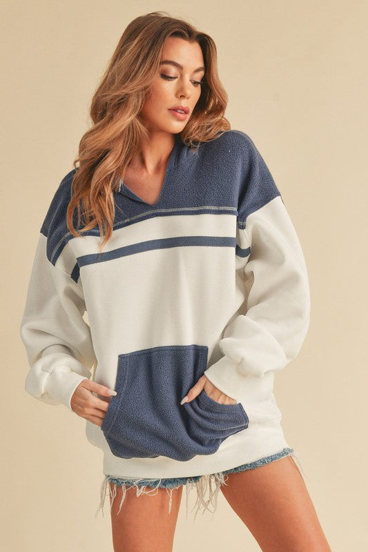 Trendy color block drop shoulder hoodie with a cozy kangaroo pocket, perfect for casual and stylish wear.