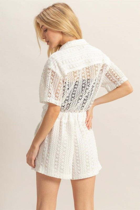 Crochet button front short sleeve romper with bohemian-inspired details, perfect for summer.