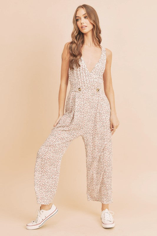 Feminine ditsy floral sleeveless wide-leg jumpsuit with a surplice neckline, perfect for casual and dressy occasions.