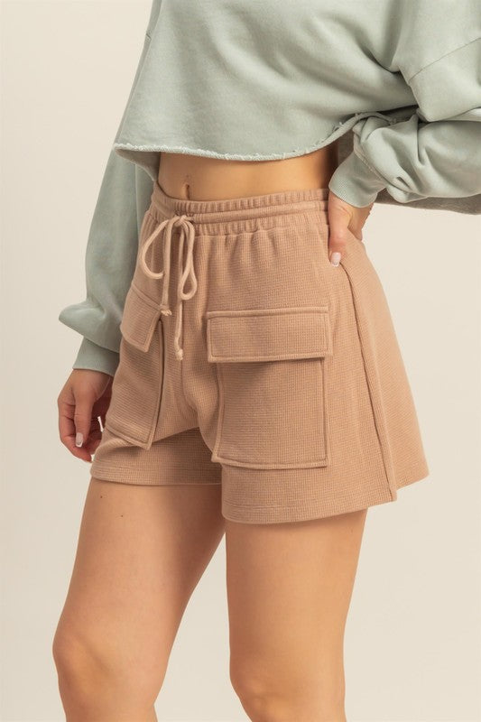 Drawstring waffle knit front pocket shorts in a soft, cozy fabric with an adjustable waist and functional pockets.