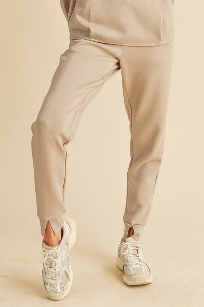 Soft elastic waist joggers with pockets, designed for comfort and casual everyday wear.