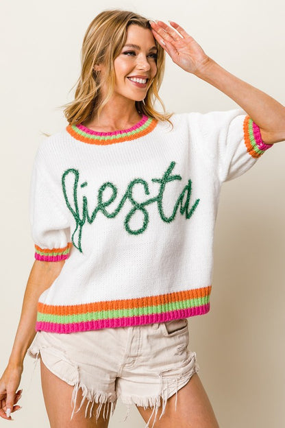 Stylish FIESTA metallic letter sweater with short puff sleeves, adding a bold and trendy touch to any outfit.