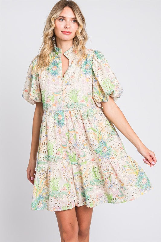 Elegant floral eyelet lace puff sleeve mini dress with a tiered ruffled hem and feminine silhouette.