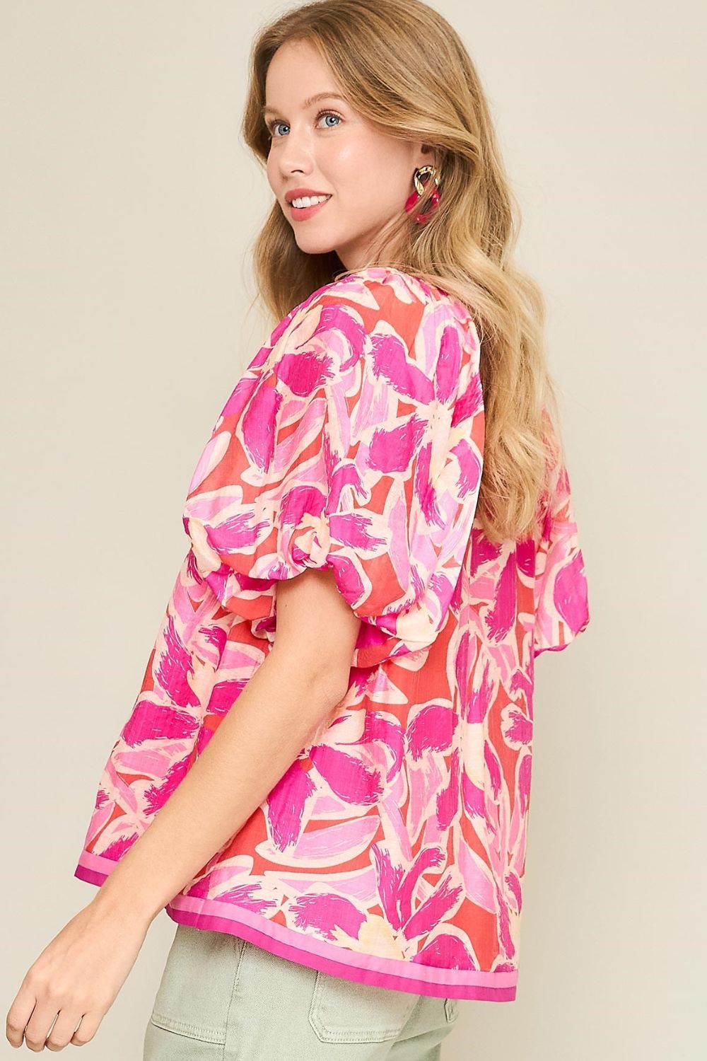 Floral blouse with notched neckline and puff sleeves, perfect for adding feminine charm to both casual and dressy looks.