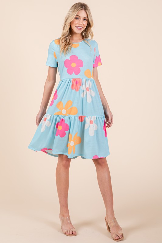 Flowy floral print tiered dress with a round neckline and short sleeves, perfect for a chic and comfortable look.