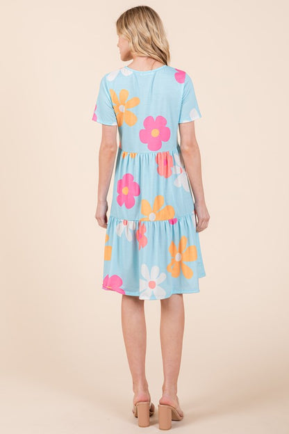 Flowy floral print tiered dress with a round neckline and short sleeves, perfect for a chic and comfortable look.