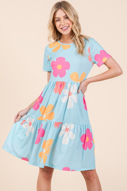 Flowy floral print tiered dress with a round neckline and short sleeves, perfect for a chic and comfortable look.