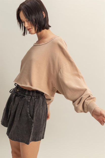 Trendy frayed detail boat neck long sleeve crop top in 100% cotton, perfect for an edgy street-style look.