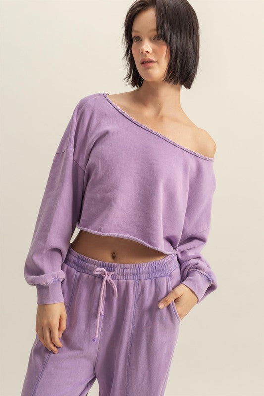 Frayed detail boat neck long sleeve crop top with a trendy distressed hem, perfect for an edgy and modern style.