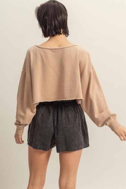 Trendy frayed detail boat neck long sleeve crop top in 100% cotton, perfect for an edgy street-style look.