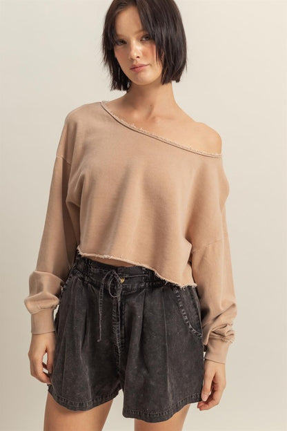 Trendy frayed detail boat neck long sleeve crop top in 100% cotton, perfect for an edgy street-style look.