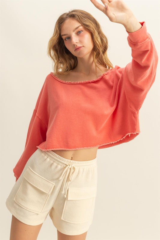 Frayed detail boat neck long sleeve crop top with raw edges, stylish & edgy for casual wear.