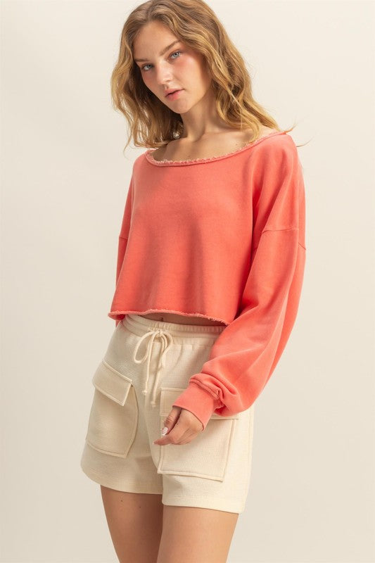 Frayed detail boat neck long sleeve crop top with raw edges, stylish & edgy for casual wear.