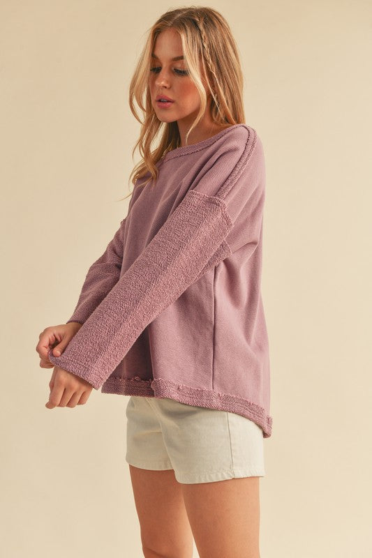 Stylish frayed edge round neck sweatshirt with a raw hem detail, perfect for a casual and modern look.