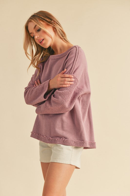 Stylish frayed edge round neck sweatshirt with a raw hem detail, perfect for a casual and modern look.