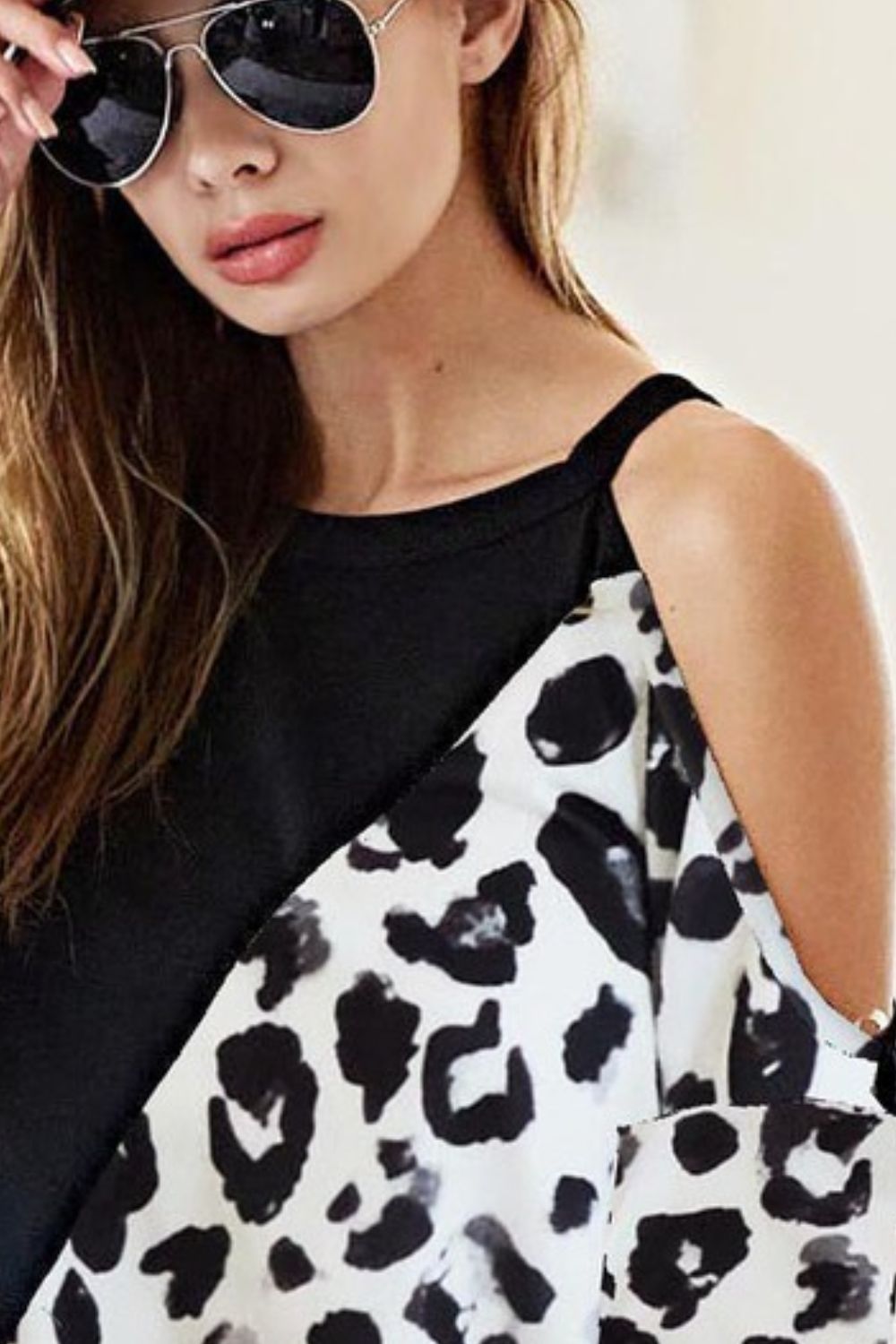 Stylish French terry leopard cold shoulder top with a trendy cutout design, perfect for casual chic outfits.