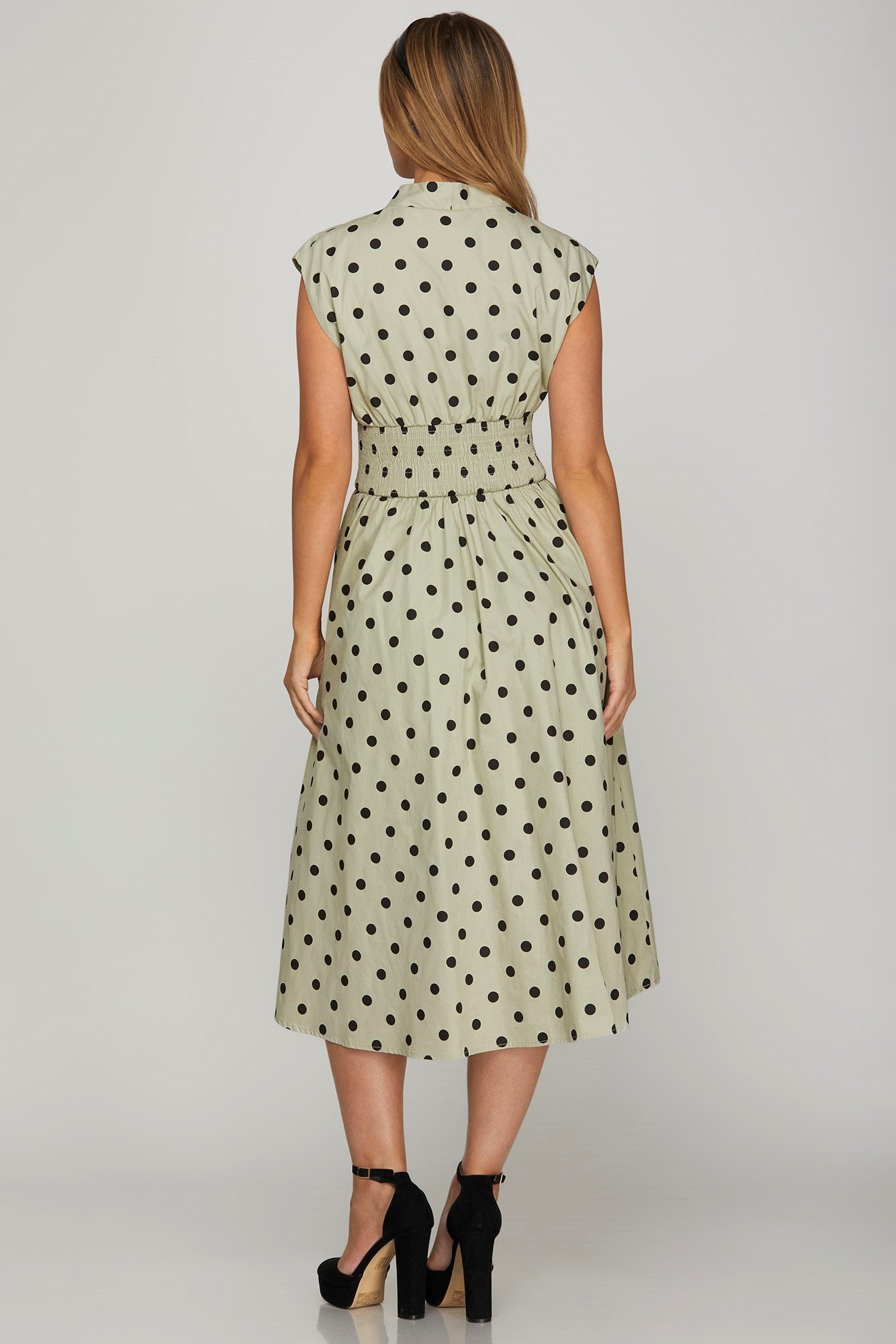 Stylish front zip polka dots cap sleeve midi dress featuring a playful yet elegant design, perfect for versatile wear.