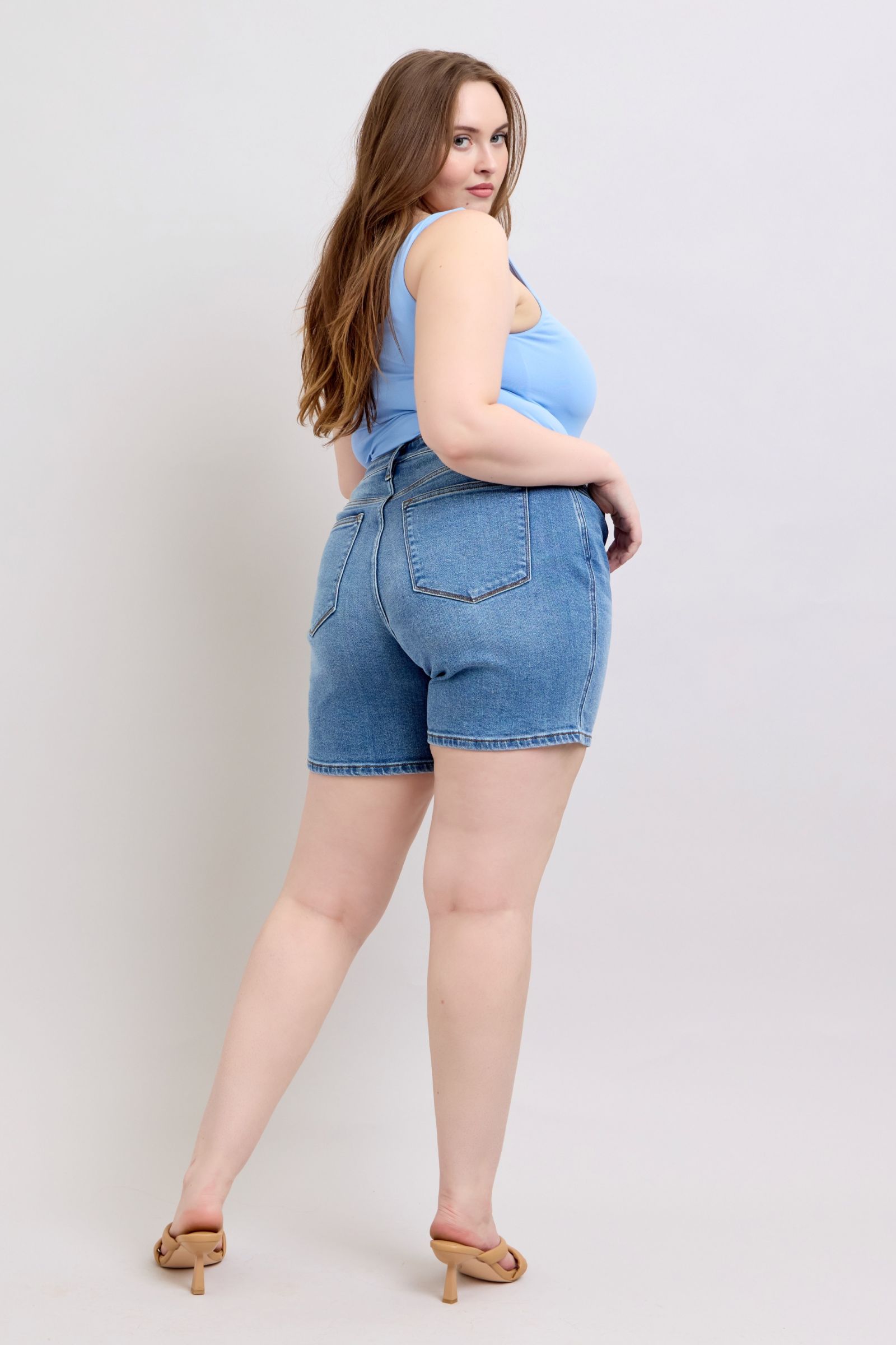 Full-size 2-button denim shorts with pockets, featuring a high-rise waist & moderate stretch for a comfortable & stylish summer look.