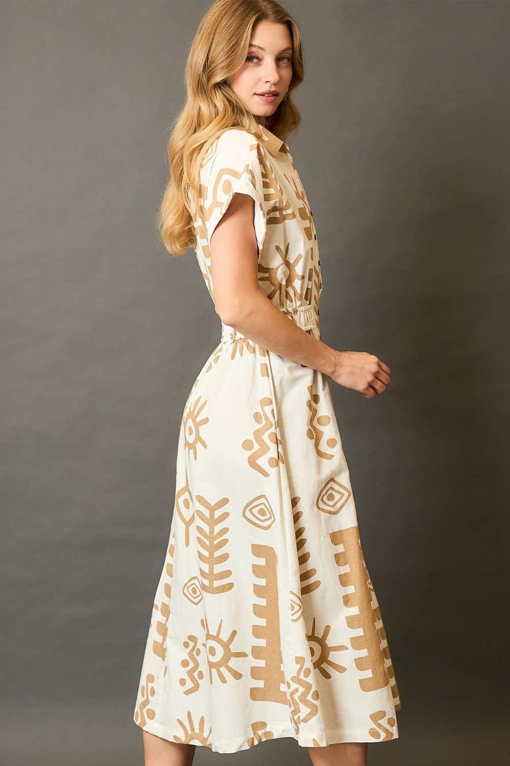 Abstract print midi dress with an elastic waist and soft fabric, designed for stylish and flattering plus-size comfort.