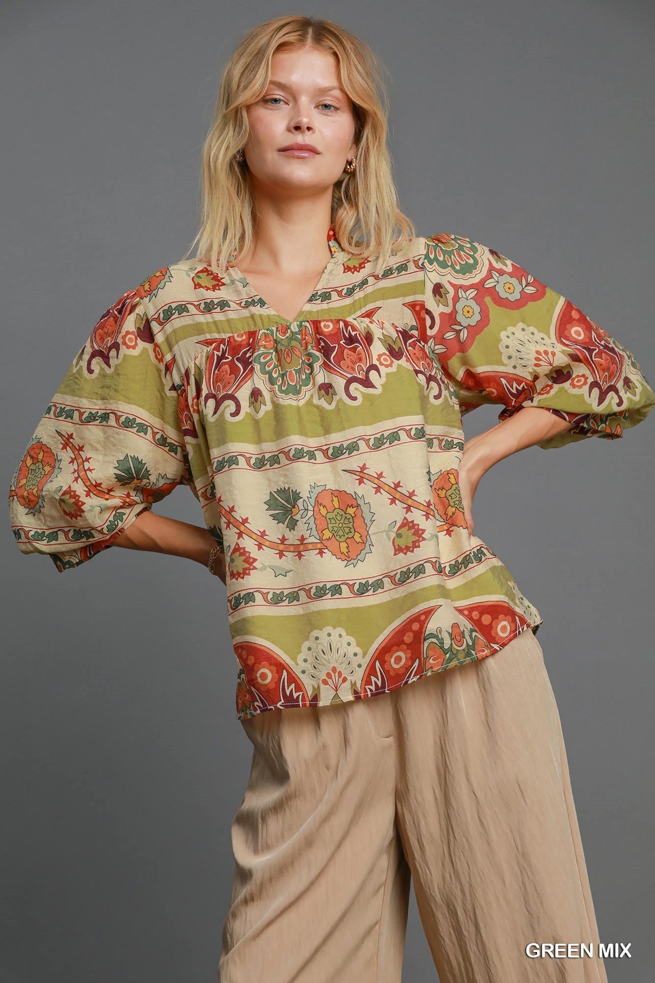 Stylish border print blouse with a notched neckline and 3/4 puff sleeves, perfect for a sophisticated and fashionable look.