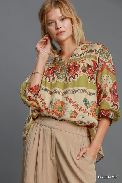 Stylish border print blouse with a notched neckline and 3/4 puff sleeves, perfect for a sophisticated and fashionable look.