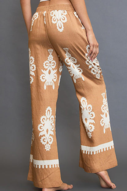 Bold border print wide-leg pants with a flattering fit, perfect for stylish and versatile outfits.