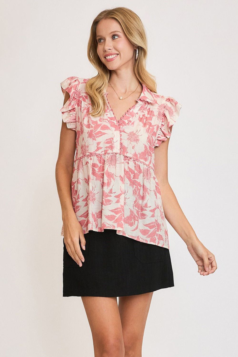 Flowy botanical print babydoll top with ruffled details, perfect for a casual and feminine look.