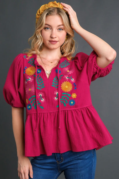 Romantic cotton gauze babydoll blouse with floral embroidery, perfect for a feminine and boho-chic look.