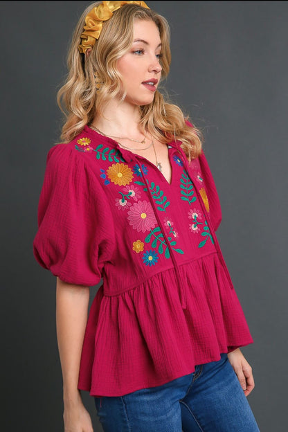 Romantic cotton gauze babydoll blouse with floral embroidery, perfect for a feminine and boho-chic look.