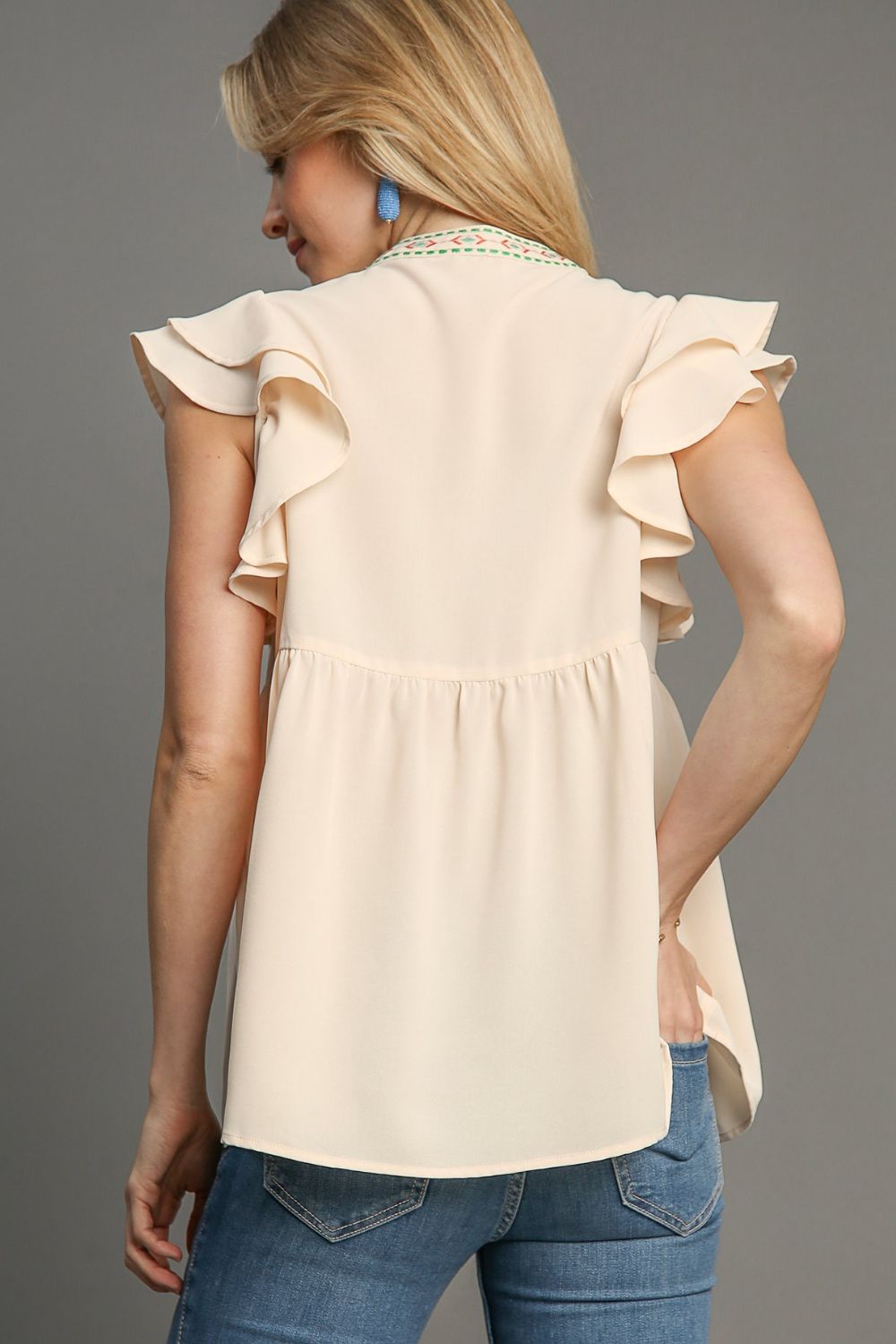 Elegant embroidered blouse with double ruffle sleeves and a notched design, perfect for a feminine and polished look.