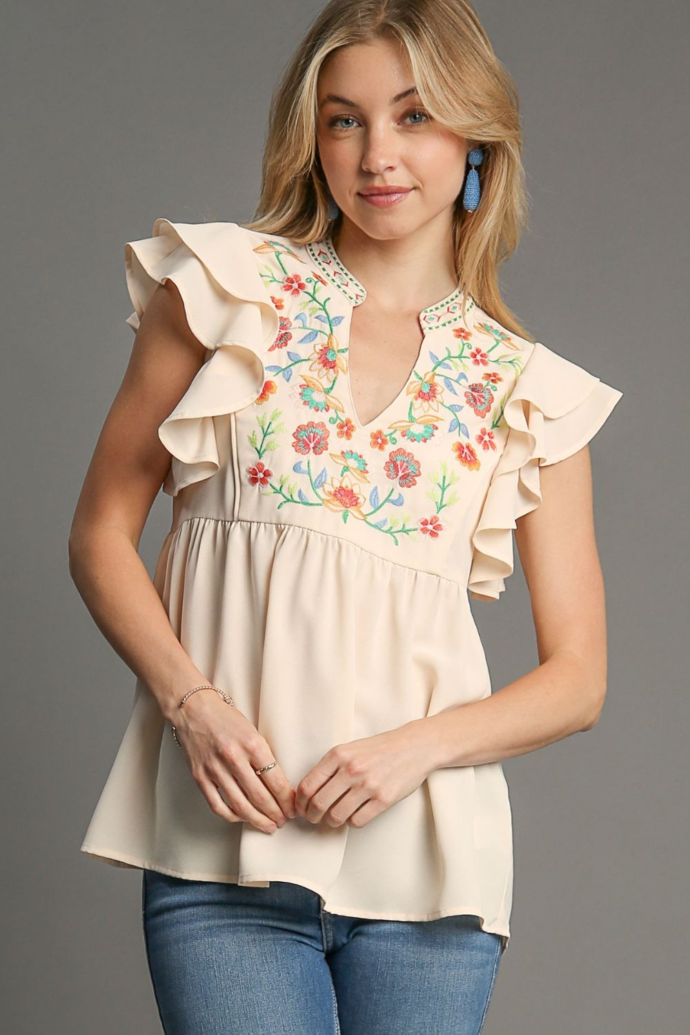 Elegant embroidered blouse with double ruffle sleeves and a notched design, perfect for a feminine and polished look.