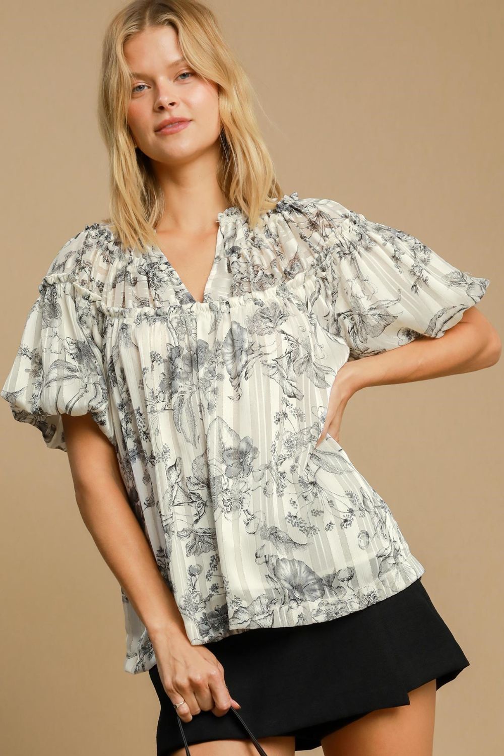 Floral print blouse with metallic accents and ruffle details, designed for a feminine and polished plus-size outfit.