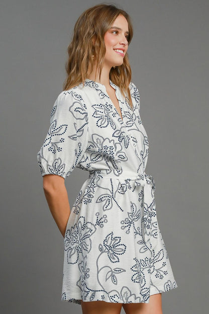 Charming floral print mini dress with puff sleeves and a stylish notched neckline, perfect for an elegant and feminine look.