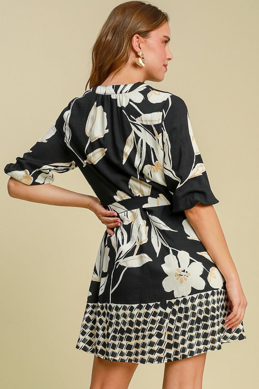 Feminine floral print mini dress with a flattering tie waist and stylish notched neckline, perfect for any occasion.