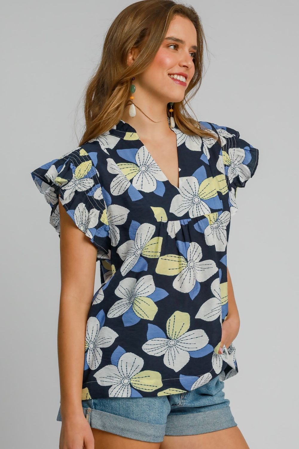 Feminine floral print ruffled cap sleeve babydoll blouse with a flattering silhouette, perfect for casual and dressy outfits.